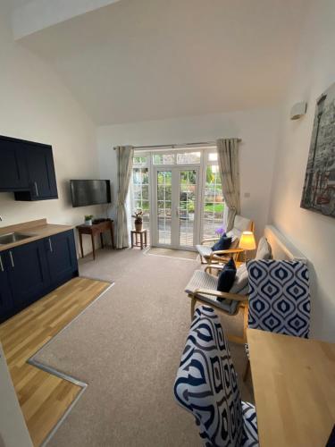 a living room with a couch and a table at Bucklands in Nailsea