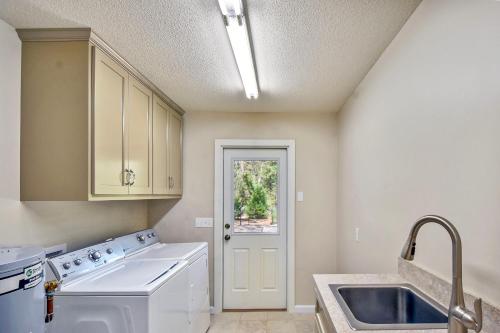 a kitchen with a white washer and a sink at Privacy Please! in Saint Simons Island