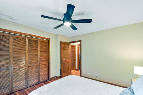 a bedroom with a ceiling fan and a bed at Privacy Please! in Saint Simons Island