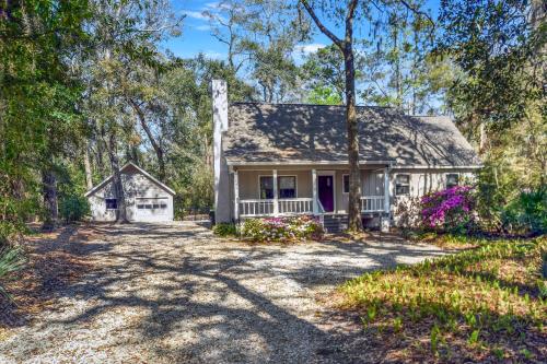 a home in the woods with a driveway at Privacy Please! in Saint Simons Island