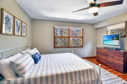 a bedroom with a bed and a flat screen tv at Privacy Please! in Saint Simons Island