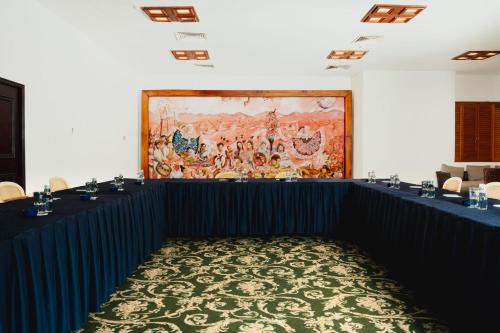 a meeting room with a large painting on the wall at Camino Real Zaashila Huatulco in Santa Cruz Huatulco