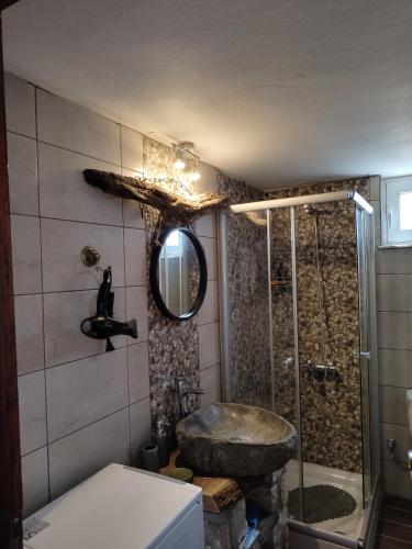 a bathroom with a stone sink and a shower at Sea Sight Vibes in Frangokastello