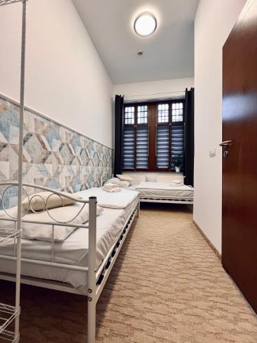 a bedroom with two bunk beds and a tub at AmaMolto Train Station in Opole