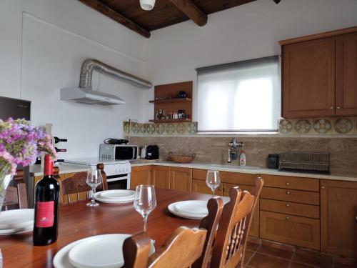 a kitchen with a table with a bottle of wine at Sea Sight Vibes in Frangokastello
