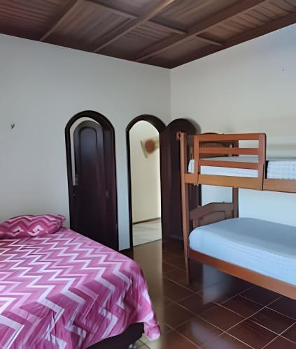 a bedroom with a bed and a bunk bed and a ladder at Casa com Piscina Grande em Salinas in Salinópolis
