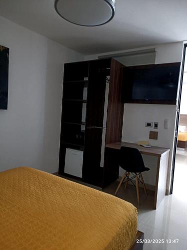 a bedroom with a desk and a bed and a table at Tepeyac 402 in León