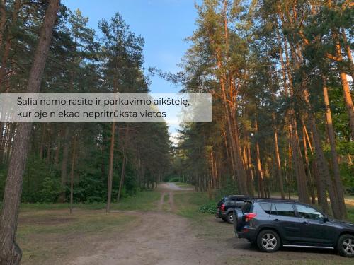 a car parked on the side of a dirt road at Palūšės Apartment in Palūšė