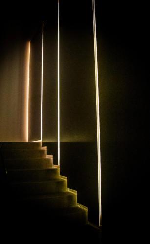 a staircase in a dark room with lights at Bilor Luxury Holidays in Subbiano