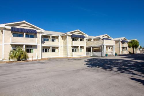 a large apartment building with a large parking lot at Palm Suites in Atlantic Beach