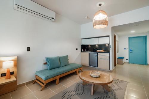 a living room with a blue couch and a table at Redcon Suites in Hurghada