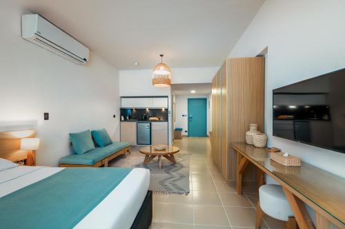 a bedroom with a bed and a living room at Redcon Suites in Hurghada