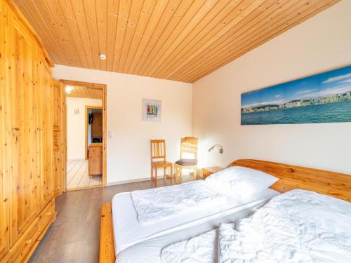 a bedroom with a bed and a wooden ceiling at Ferienhaus mit einladendem Platzangebot in Granzow