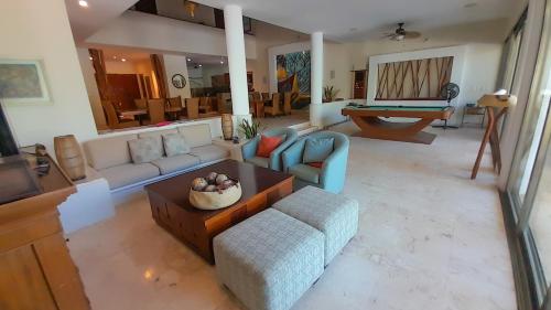 a living room with a couch and a table at Lemnus Luxury villa walking distance to Chicxulub in Chicxulub