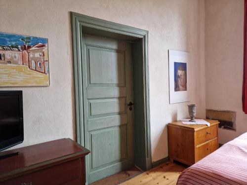 a bedroom with a door and a bed and a television at Ferienwohnung in Steffenshagen mit Garten in Steffenshagen