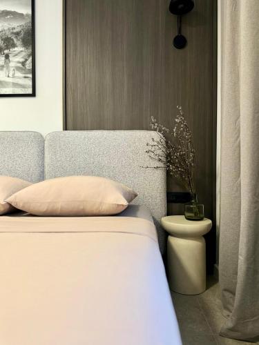 a bedroom with a bed with a white bedspread at Miol apartment in Kaštela