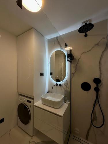 a bathroom with a sink and a mirror at Miol apartment in Kaštela