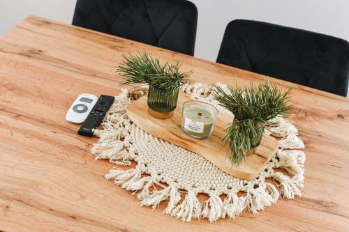 a wooden table with two plants on top of it at Aleksandrówka in Szlembark
