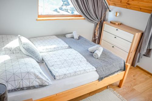 a bedroom with a bed and a window at Aleksandrówka in Szlembark