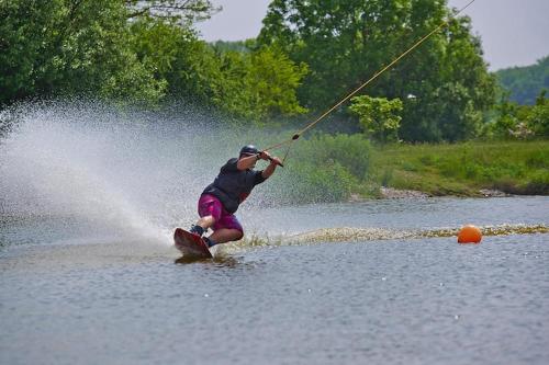 a man water skiing on a body of water at Appartements im Freizeitpark Weissenhäuser Strand in Weissenhäuser Strand