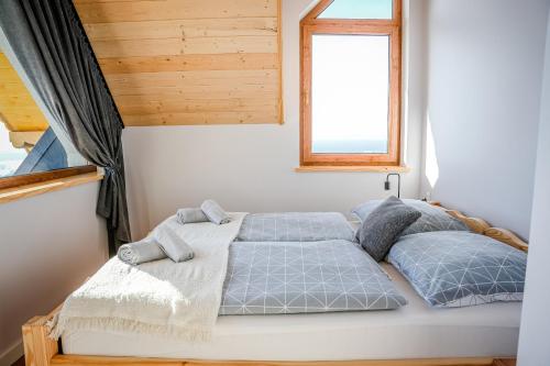 a bedroom with a bed and a window at Aleksandrówka in Szlembark