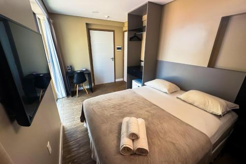 Ένα ή περισσότερα κρεβάτια σε δωμάτιο στο Easy Suites Natal Hotel