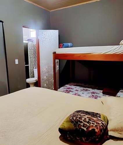 a bedroom with two bunk beds and a mirror at Temporada no Atalaia in Salinópolis