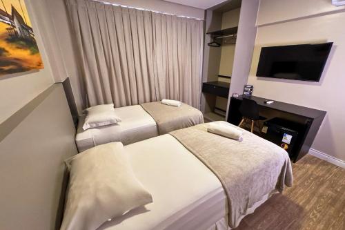 Ένα ή περισσότερα κρεβάτια σε δωμάτιο στο Easy Suites Natal Hotel