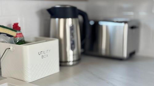 a kitchen counter with a coffee pot and a silver appliance at Luxury 8 Berth Caravan At Butlins Skegness in Skegness