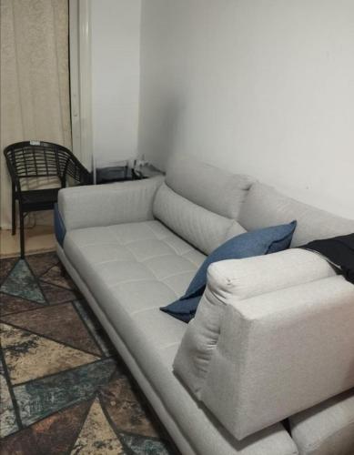 a white couch in a living room with a chair at قرية بالميرا العين السخنة in Ain Sokhna