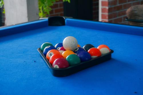 a tray of pool balls on a pool table at Bandar Botanic Klang lux bungalow Home stay in Pelabohan Klang