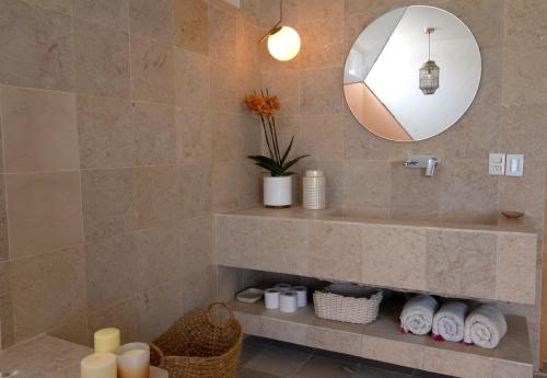 a bathroom with a sink and a mirror and towels at Casita Perla Sustainable Villa with Mountain View, Long Pool, King, Grill in Texcalpan