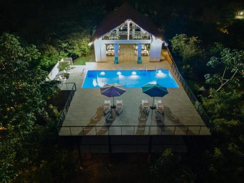 an overhead view of a swimming pool at night at Tardes Doradas in Quepos