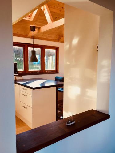 a kitchen with a island in the middle of a room at Seaview Studio in Forrabury