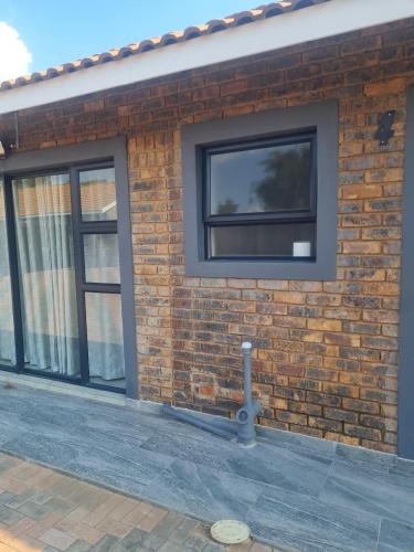 a brick building with a window on it at Lukhanyo Guest House in Northam