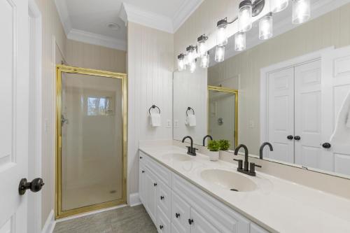 a white bathroom with two sinks and a shower at What A View in Terrell