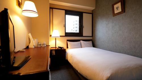 Ένα ή περισσότερα κρεβάτια σε δωμάτιο στο Tokyo Inn - Vacation STAY 26539v