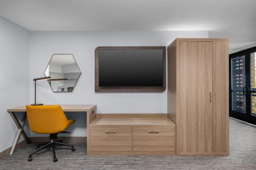an office with a desk and a tv and a chair at Holiday Inn Express Hilton Head Island by IHG in Hilton Head Island