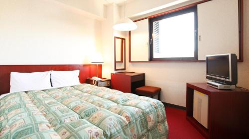 a hotel room with a bed and a tv at Tokyo Inn - Vacation STAY 26577v in Tokyo