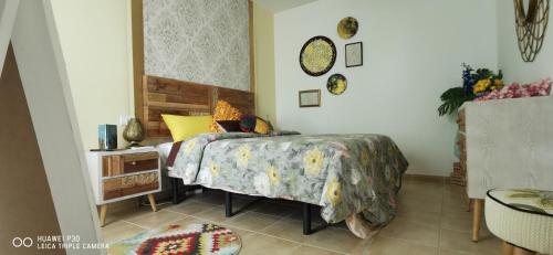 a bedroom with a bed and a table with a bedspread at Wind Rose Duplex in Gran Tarajal