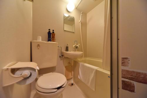 a white bathroom with a toilet and a sink at Hotel Nomad - Vacation STAY 61779v in Hitachi