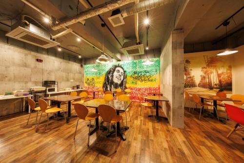 a restaurant with tables and chairs and a painting on the wall at Hotel Nomad - Vacation STAY 61779v in Hitachi