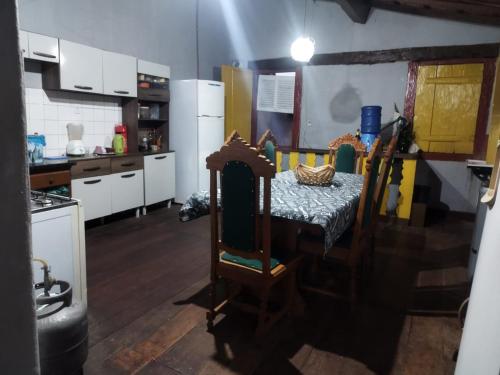 a kitchen with a table in the middle of a room at Hospedaria Vó Helena in Paracatu