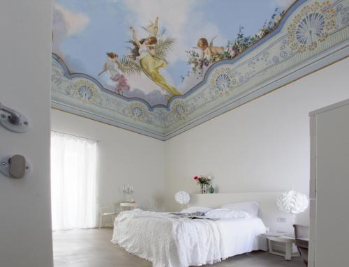 a bedroom with a painted ceiling and a bed at Shalai - Exclusive SPA and small gourmet hotel in Linguaglossa