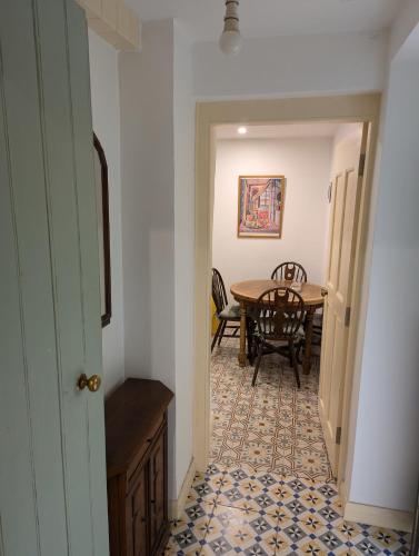 a hallway with a table and a dining room at Herdsmans Cottage in Slane