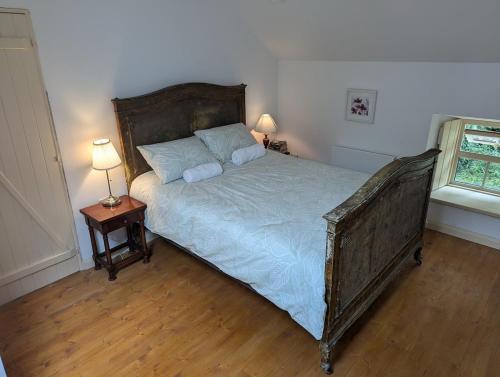 a bedroom with a bed with two pillows on it at Herdsmans Cottage in Slane
