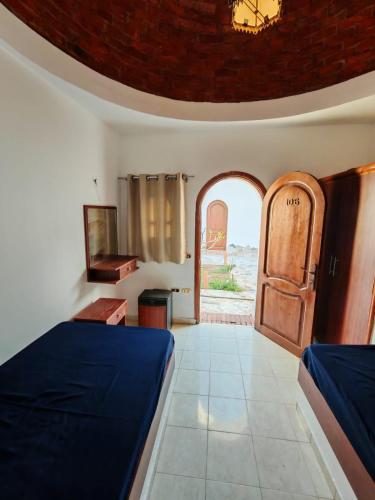 a bedroom with a bed and an arched window at Ghazala hotel dahab in Dahab