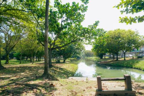 a bench in a park next to a river at Bandar Botanic Klang lux bungalow Home stay in Pelabohan Klang