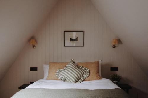 a bedroom with a bed with two pillows on it at The Penn in Windermere