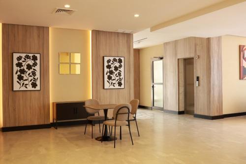 a waiting room with chairs and a table in a building at BHomed Shaab in Kuwait